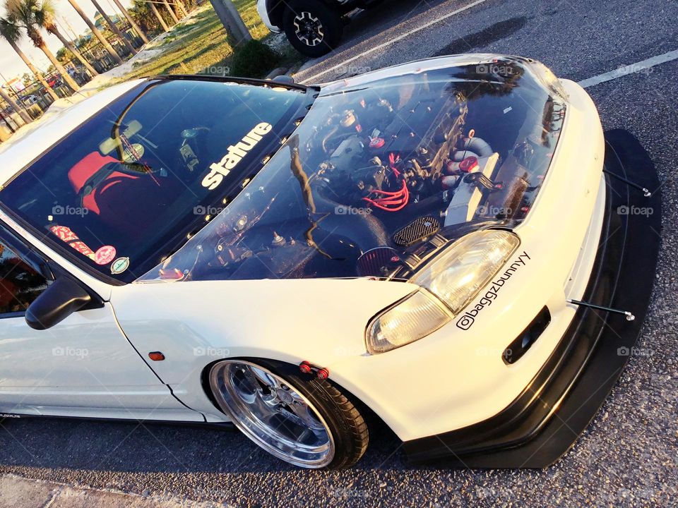 Now you can see the workings of your engine without lifting the hood. White Honda Civic EK Hatchback with Transparent Hood. 