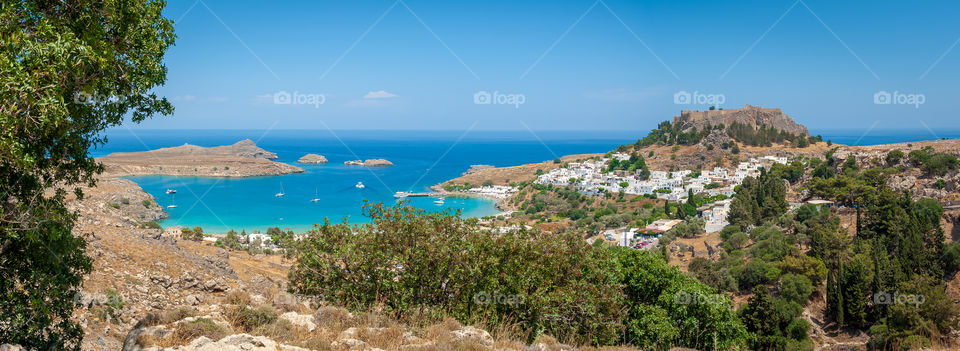 Panoramic view at Lindos village with Lindos Acropolis and Castle of the Knights of St. John. Island of Rhodes. Greece.