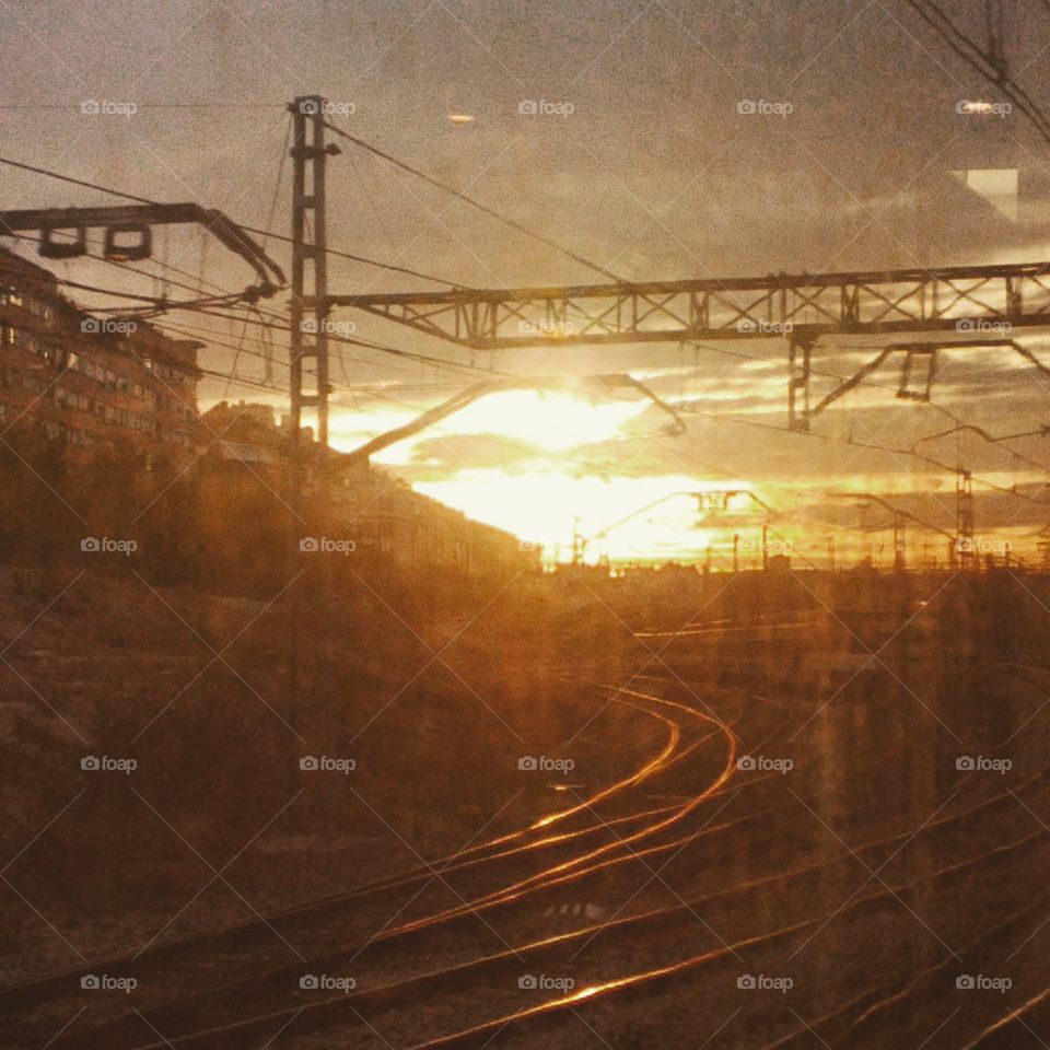 Railway tracks leading into the sunset