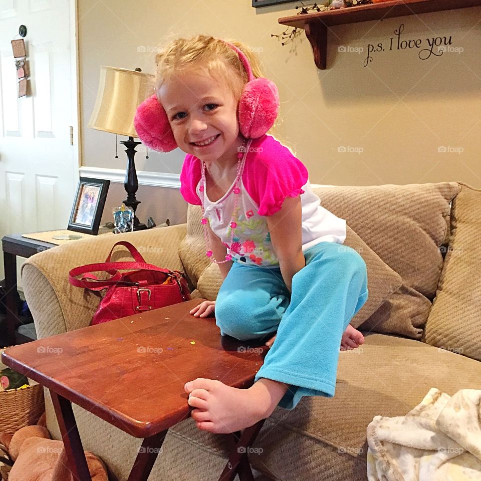 Smiling little girl with earmuffs