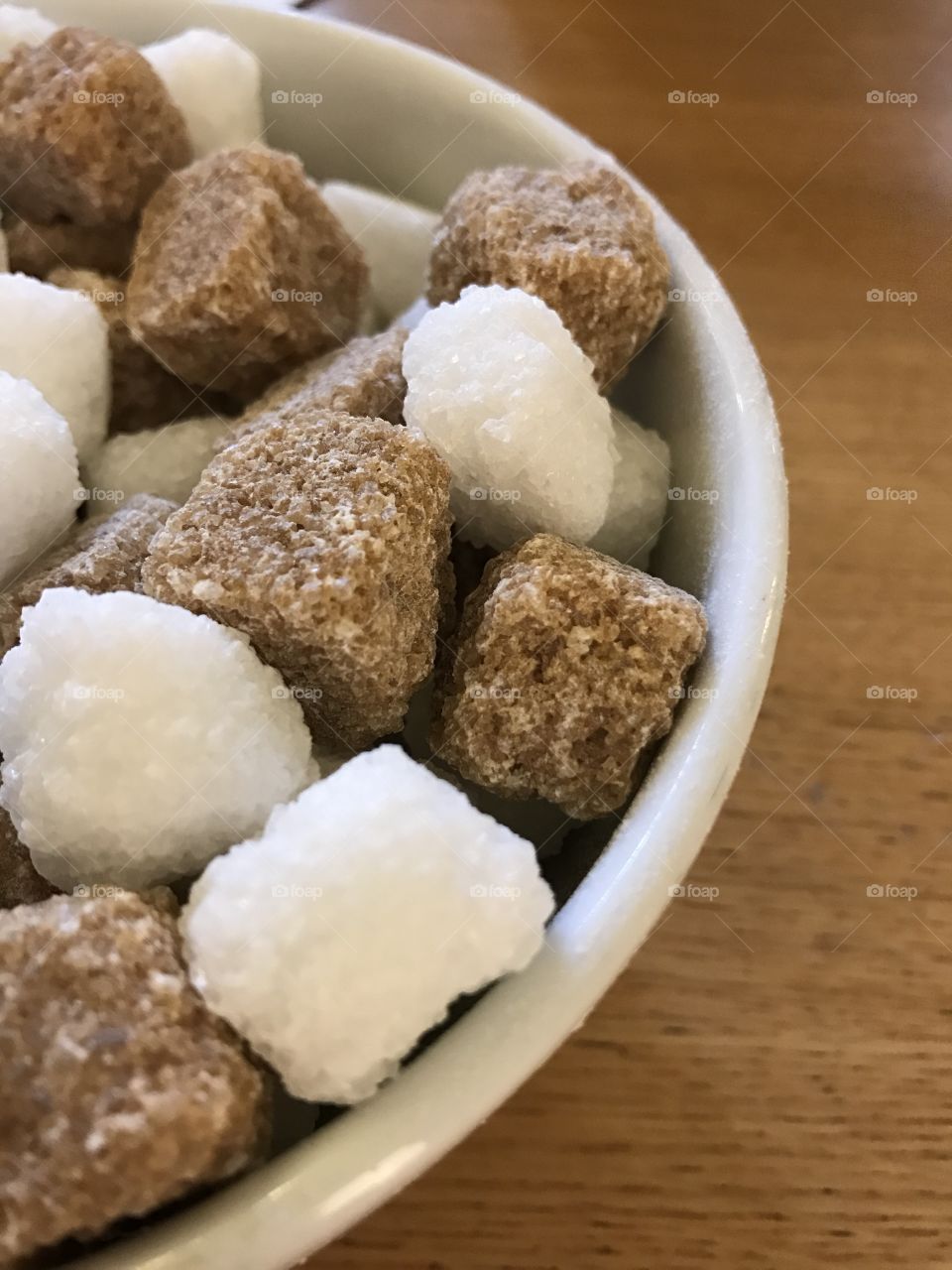 Sugar cubes in a bowl on a table 