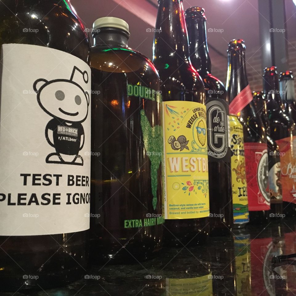 Beer bottles lined up at a bottle share