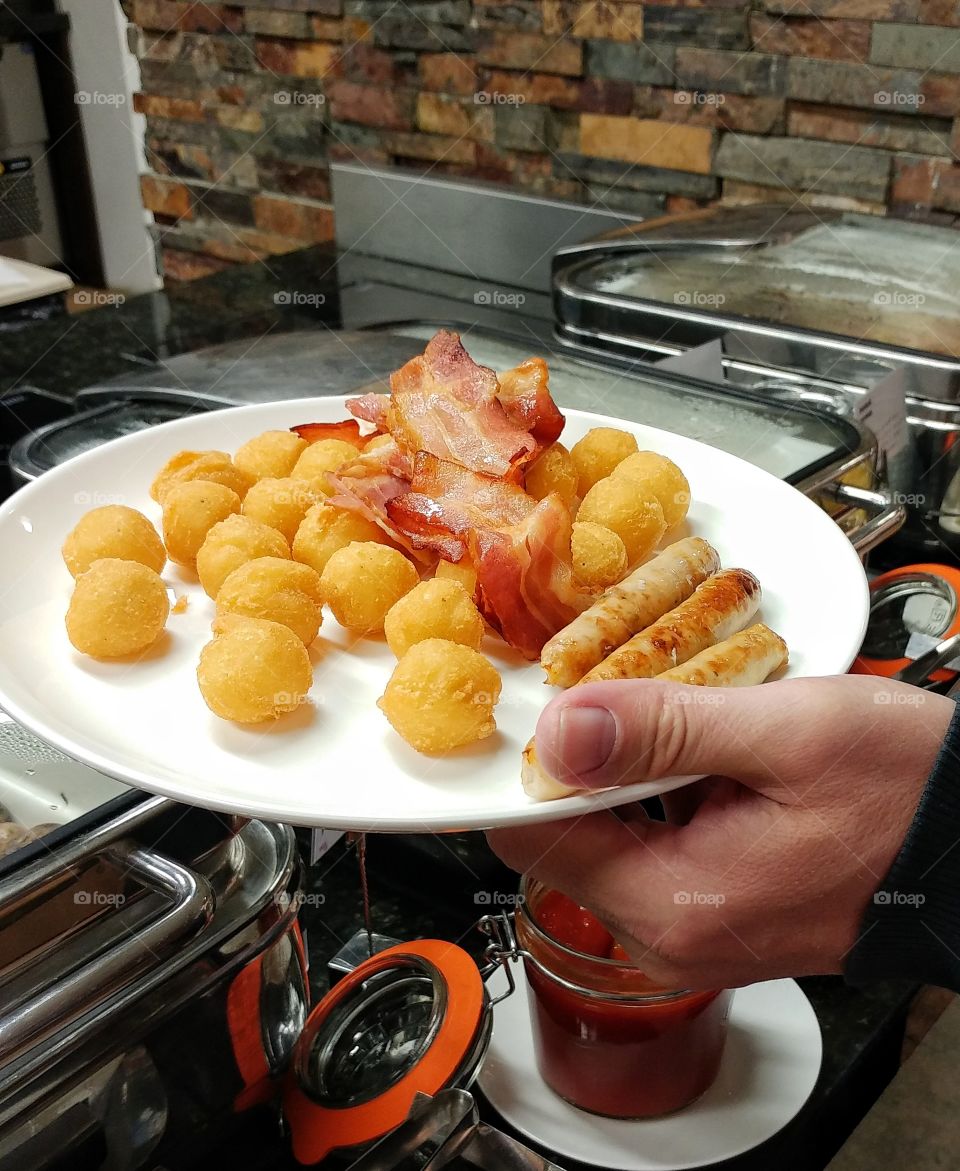 This my colleague's hand holding that plate of food.