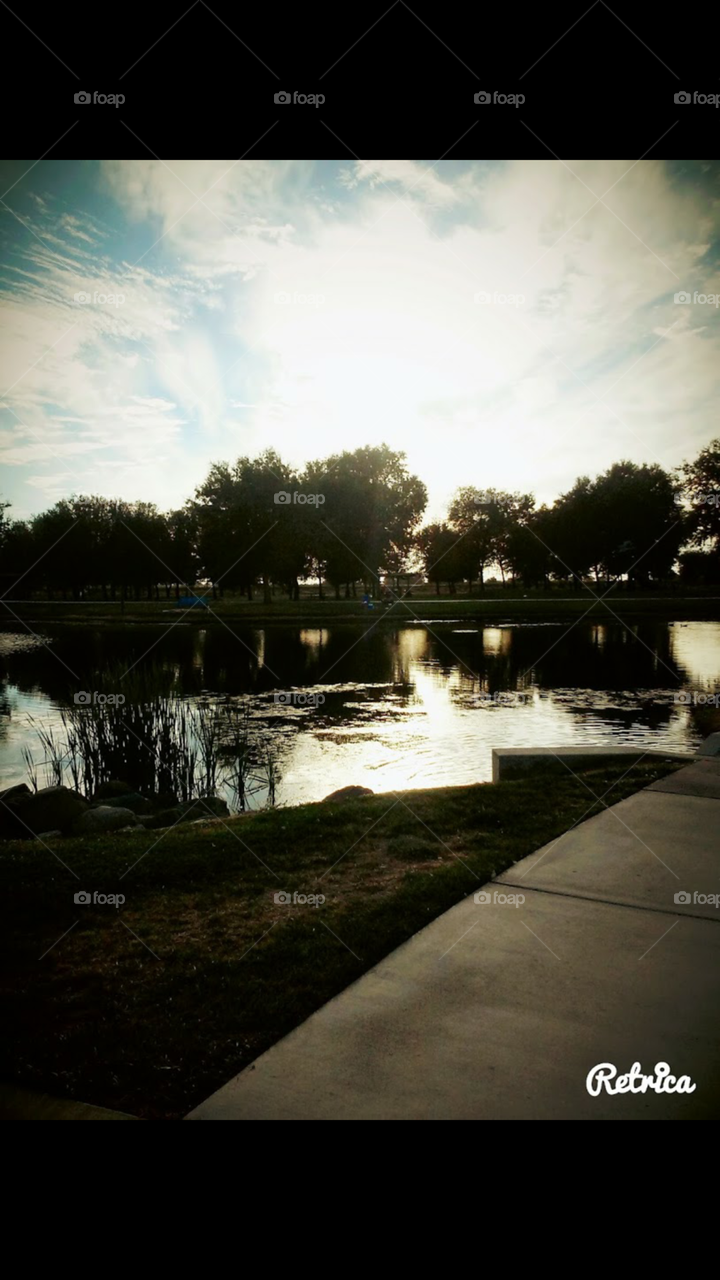 The sun setting on the lake in Mickey grove park located in Lodi, California