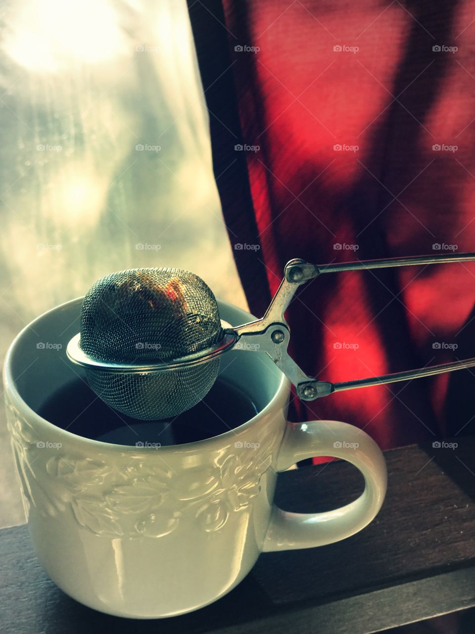Cup of tea with tea strainer