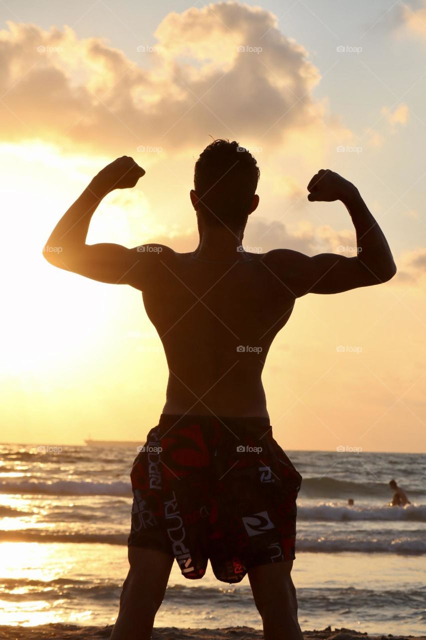 Strong guy on the beach