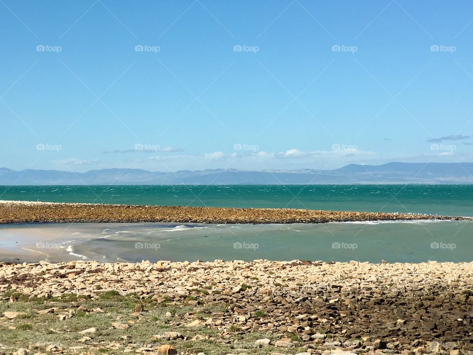 Australian southern coastline ocean bay with mountains in background 