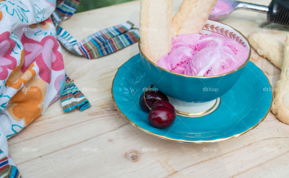 Pink ice cream scoops on wood table