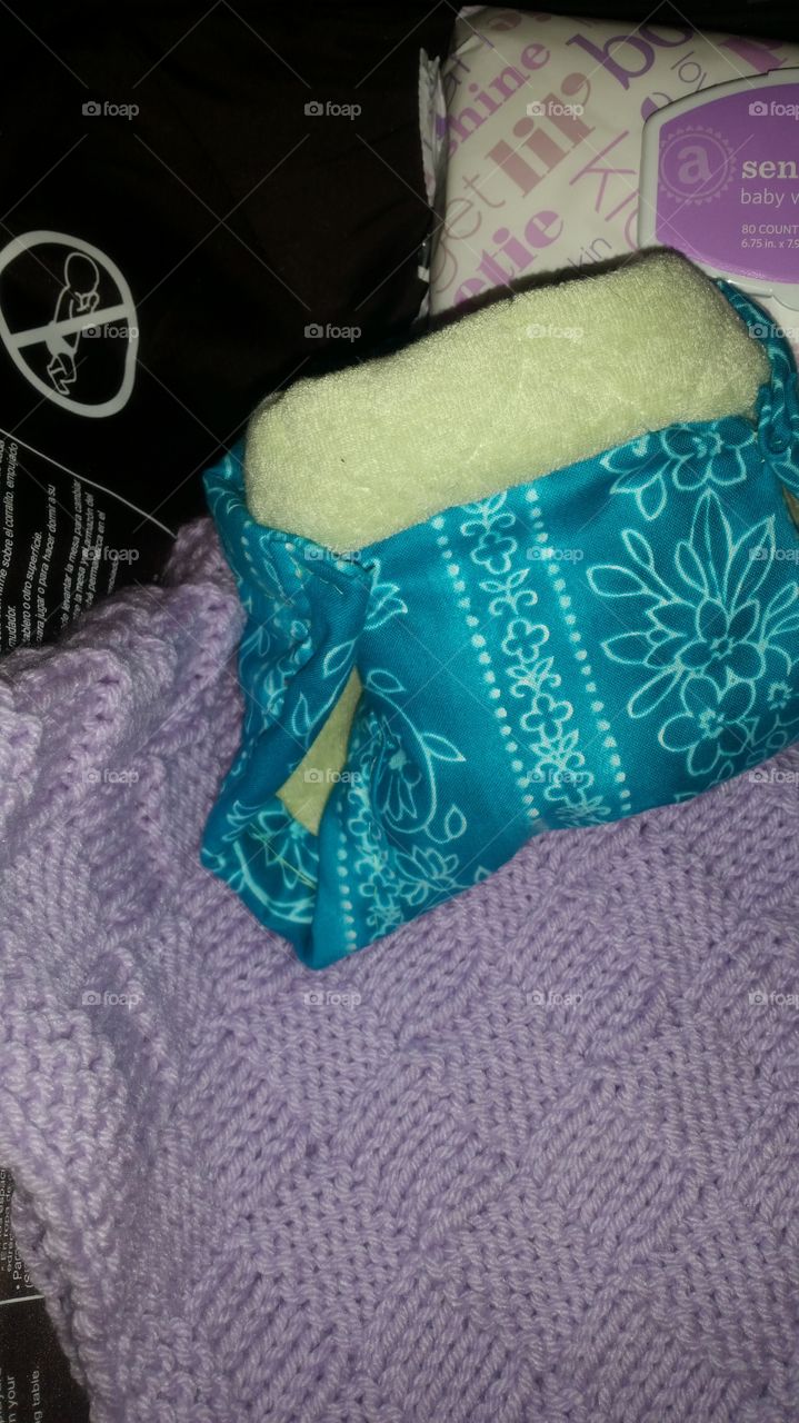 Homemade cloth diaper with wipes and receiving blanket on a changing station