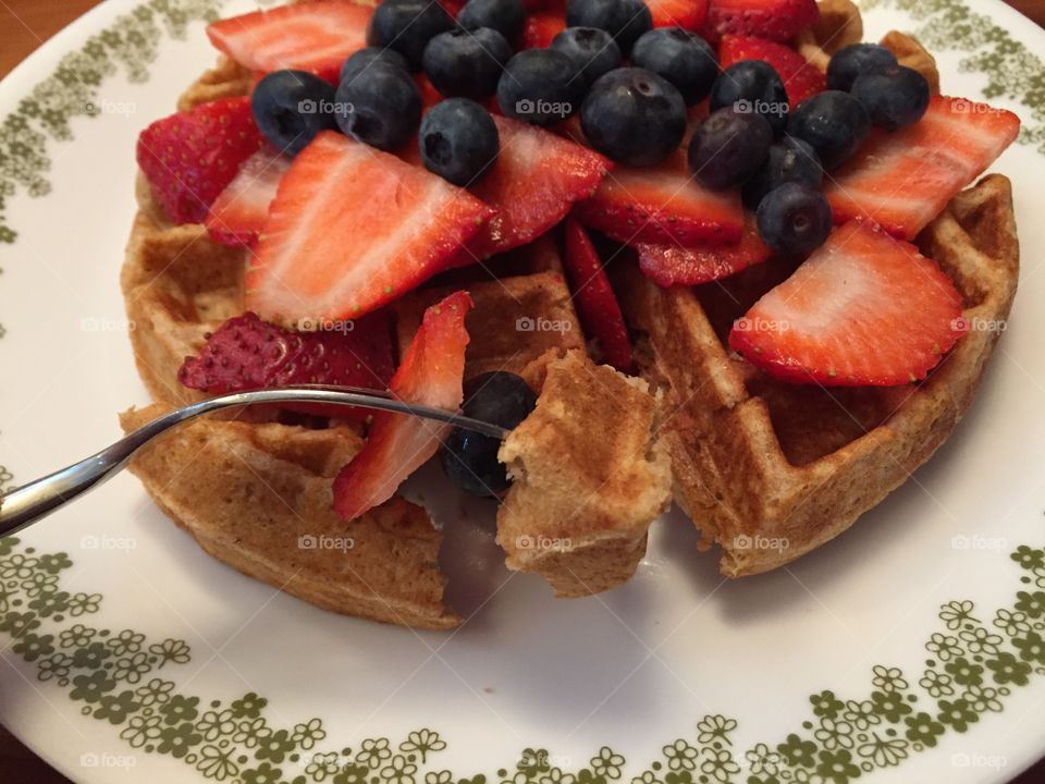 Close-up of waffle with berry fruits in plate