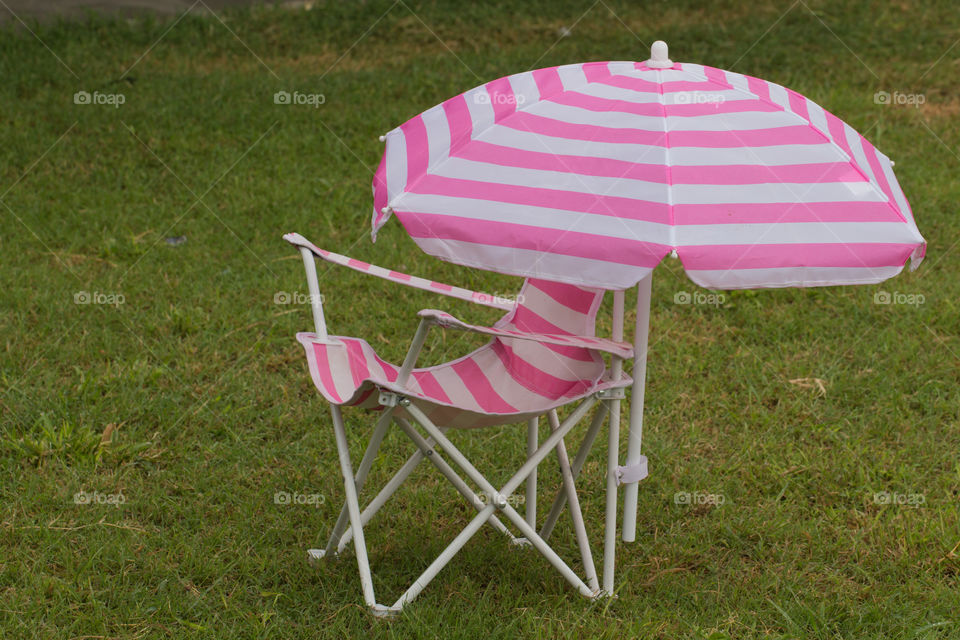 Pink chair and umbrella