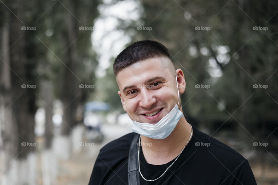 smiling man with medical protective mask