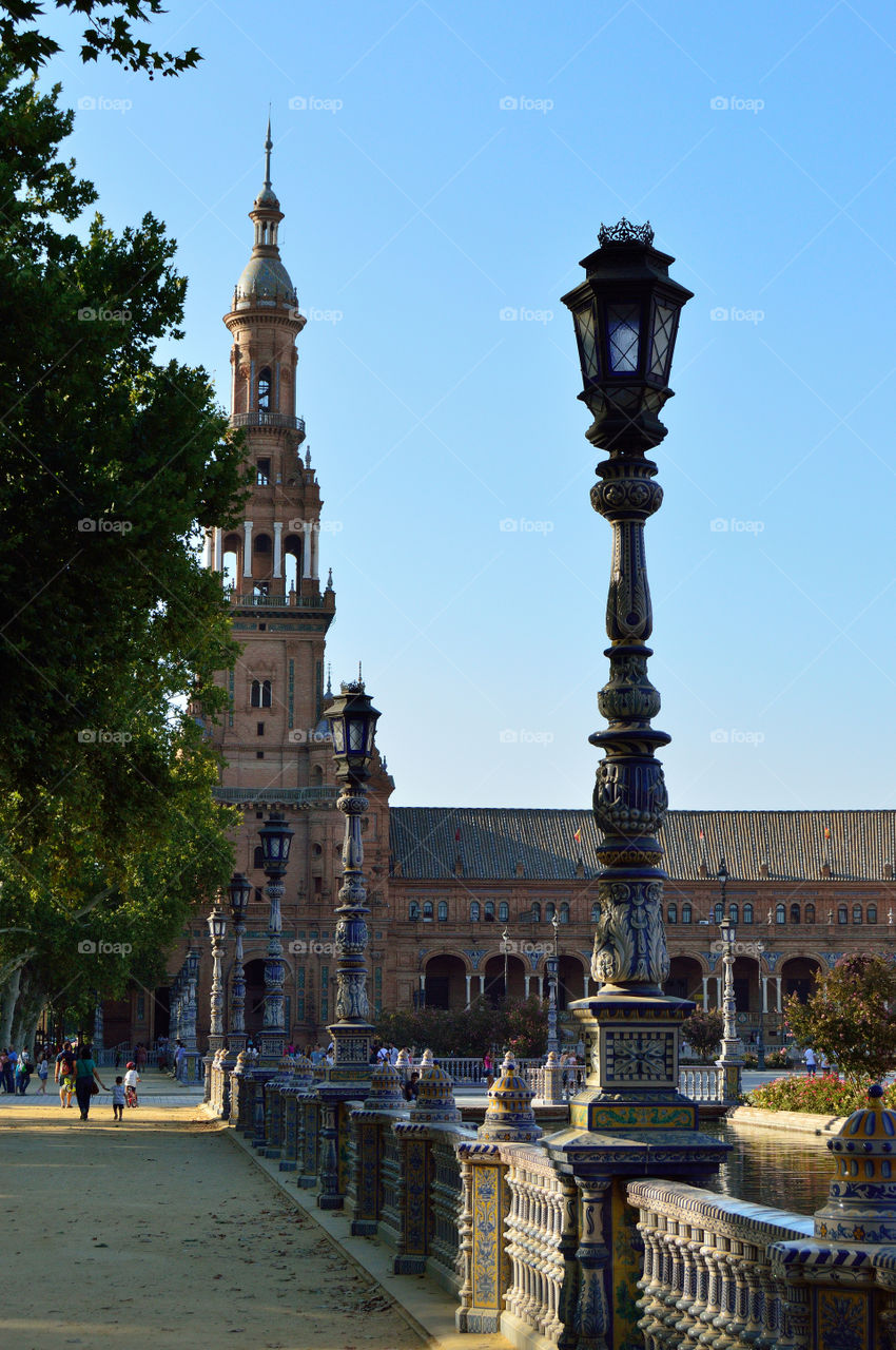 View of the North Tower and street lamps at Plaza de España in Sevilla, Spain.