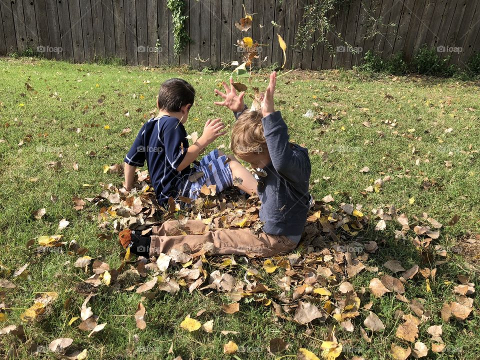 Children enjoying fall leaves