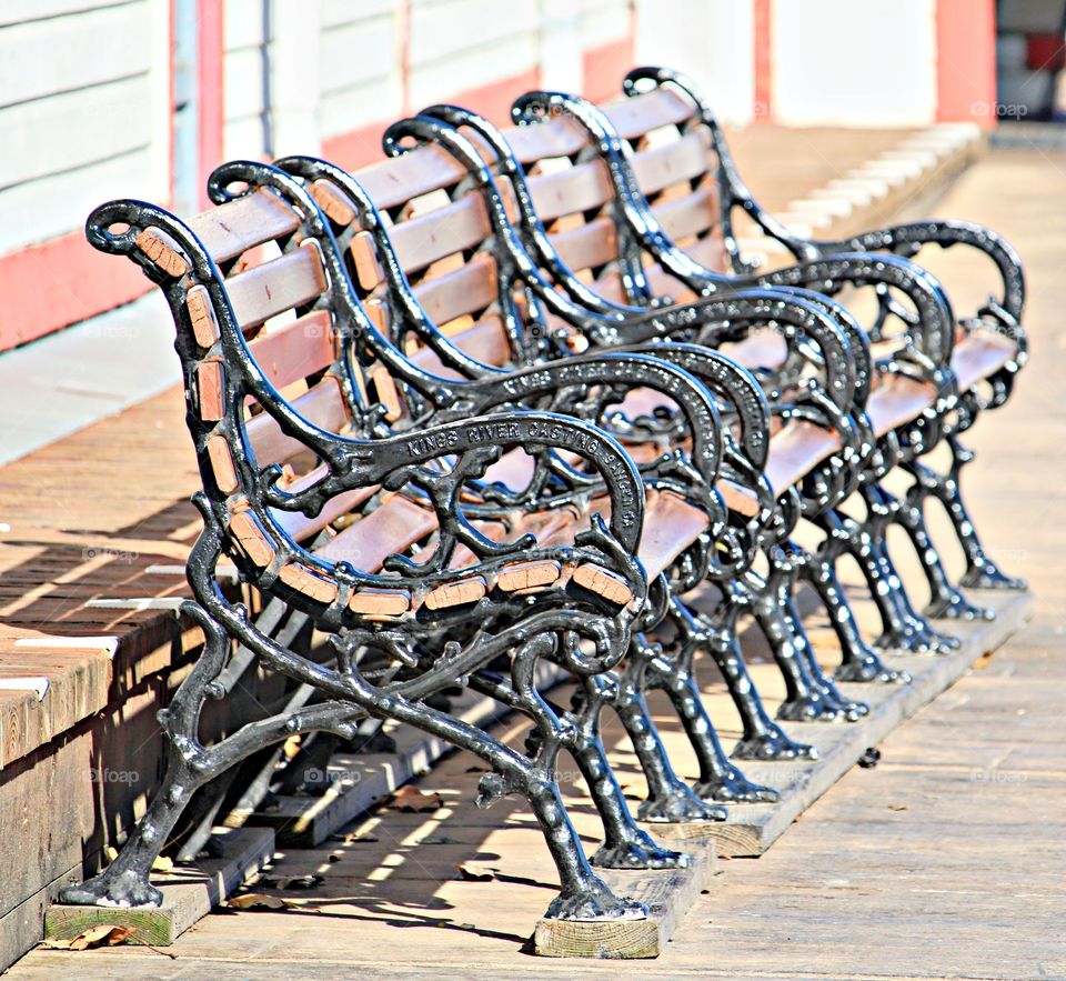 bench seats aligned in a roll on the boardwalk in the capital of Sacramento California.