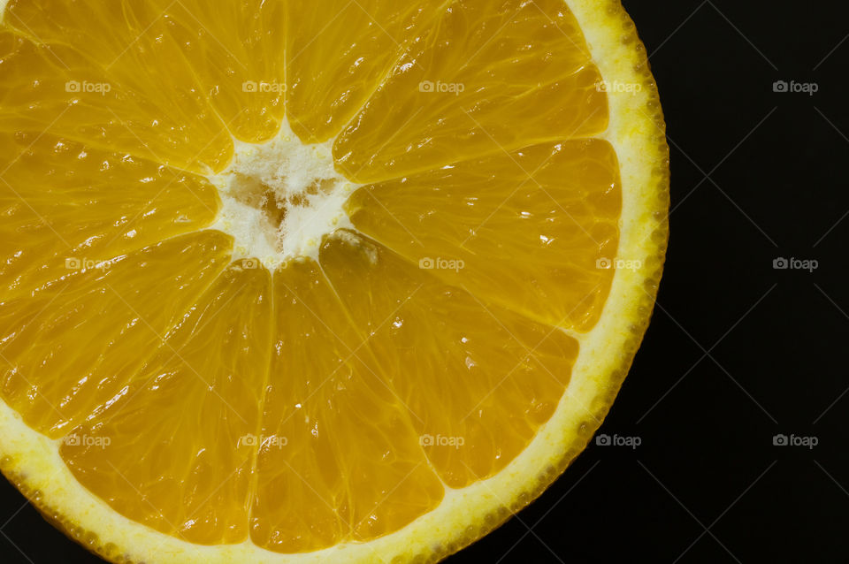slice of mandarin on a black background