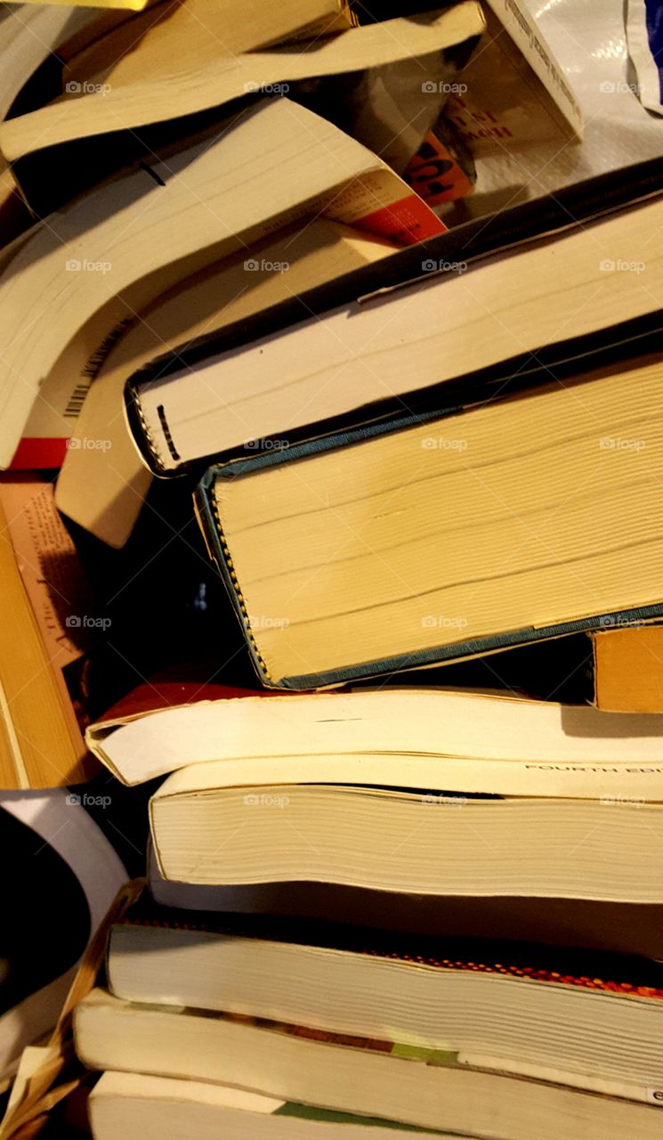 A pile of books sit waiting to be put away after they've been read.