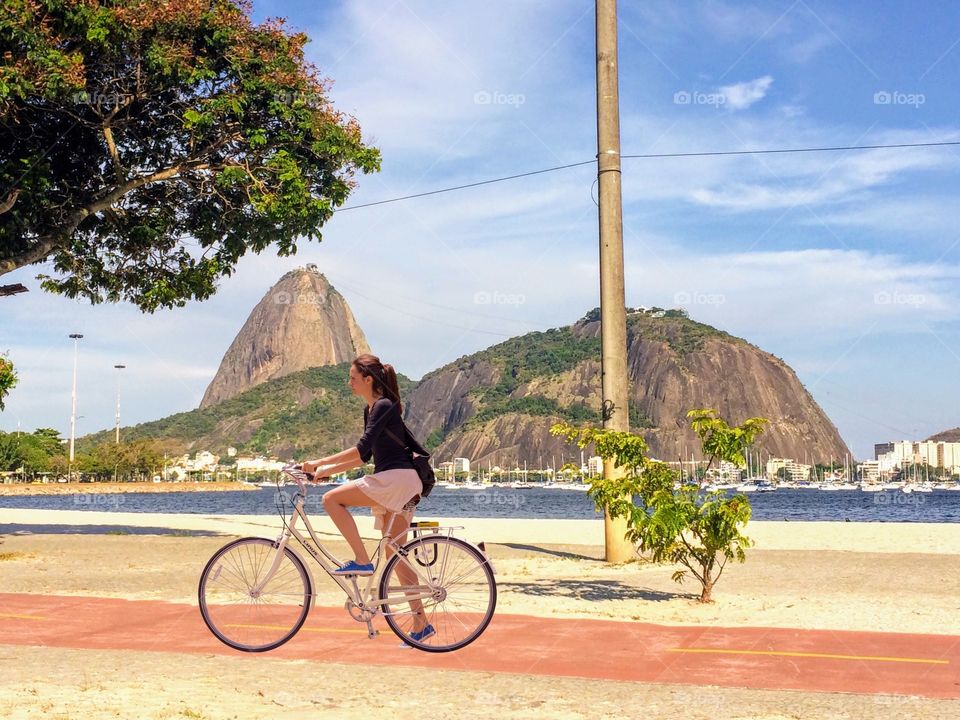 Young woman cycling on the edge of Rio de Janeiro, Brazil