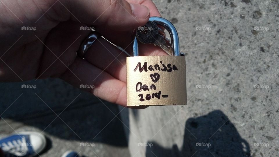 Celebrating our marriage by putting a lock on the bridge on our honeymoon
