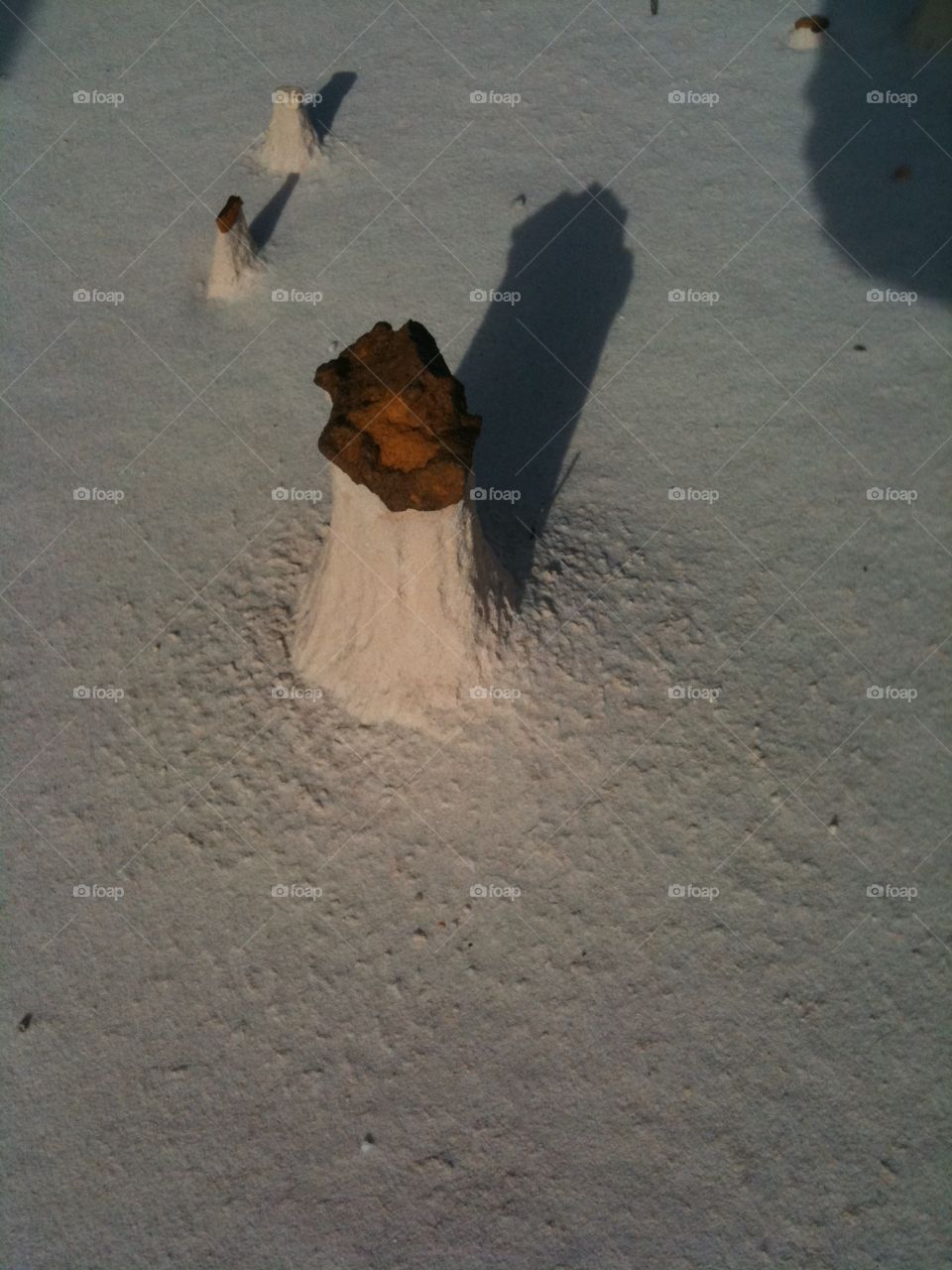 Rock balanced on sand pedestal 