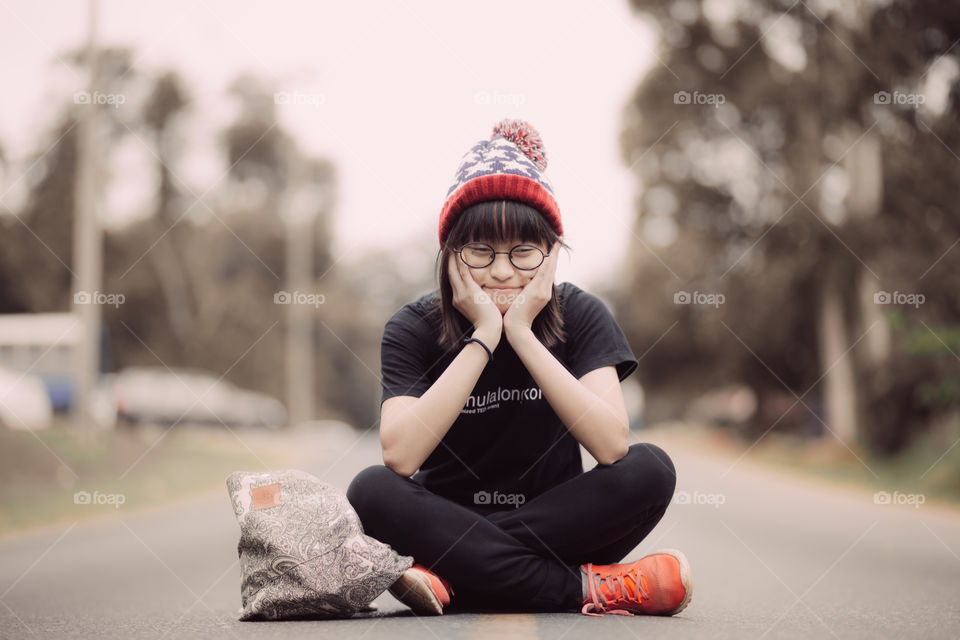 Tourist girl sitting on the road 