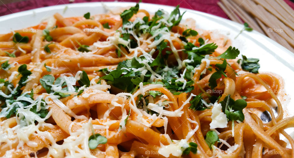 Whole wheat linguine with tomato sauce and garnish