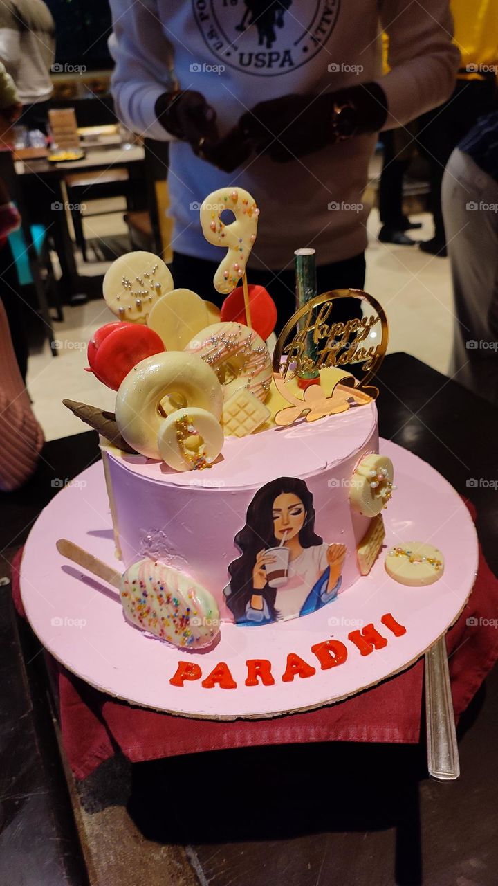 Charming in pink, the dress exudes elegance. Cake pops, unique in shape, add a playful touch. A harmonious blend of style and sweetness, perfect for any occasion