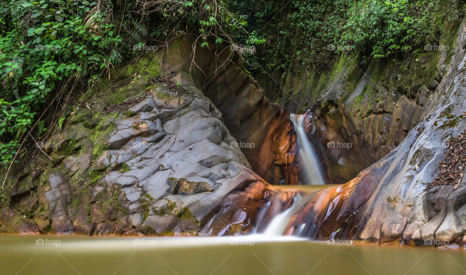 Orange colored waterfall on the volcanic Cajon River in Costa Rica 