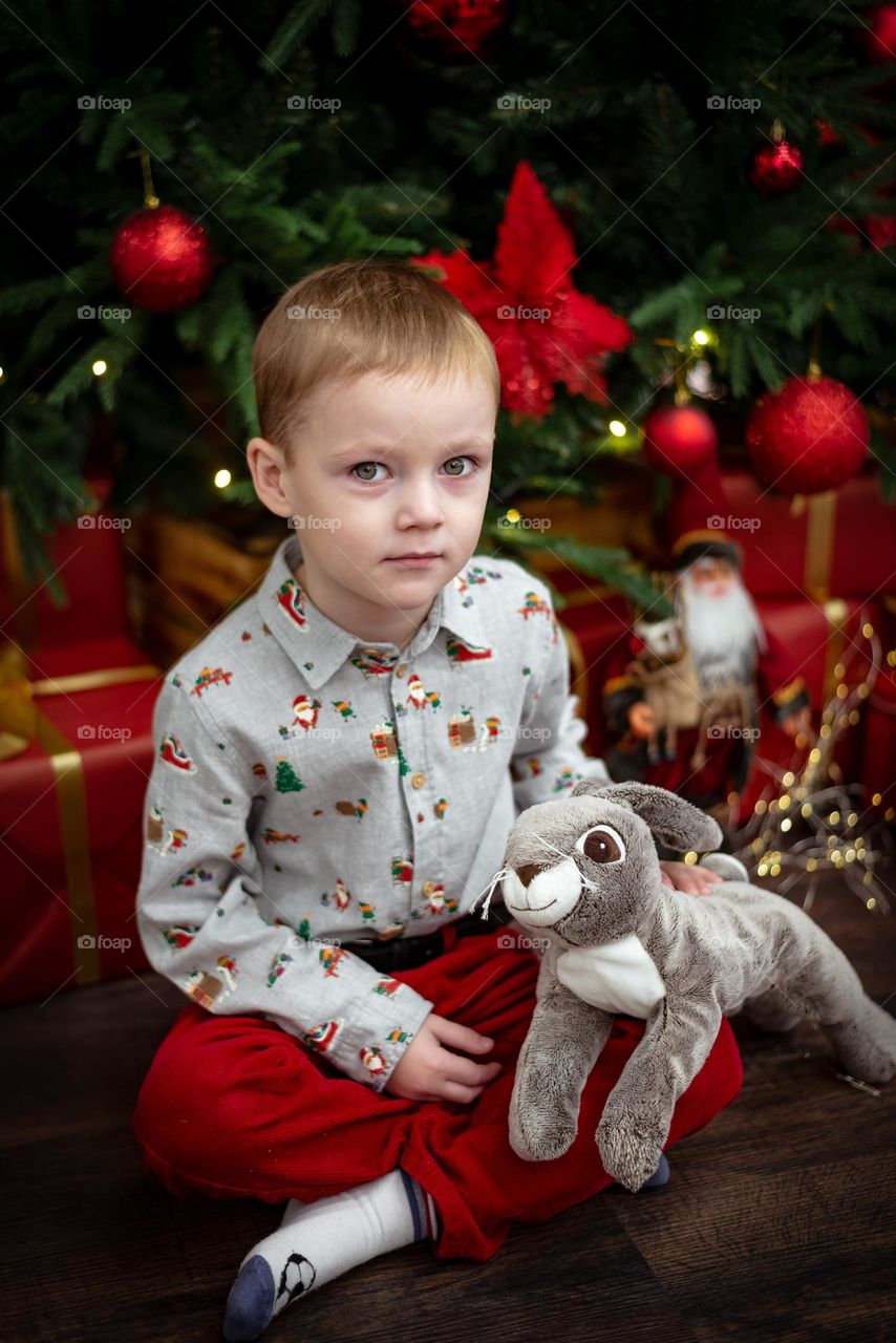 Red haired boy with toy rabbit 