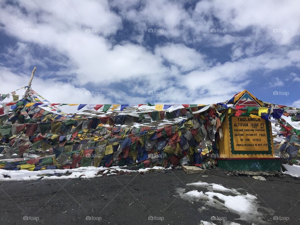 A high pass on a northern Indian road is filled with prayer flags.
