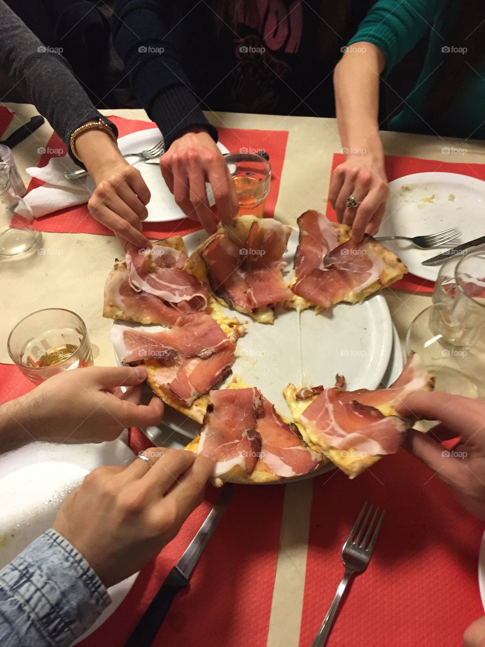 People are taking a slide of pizza from the plate