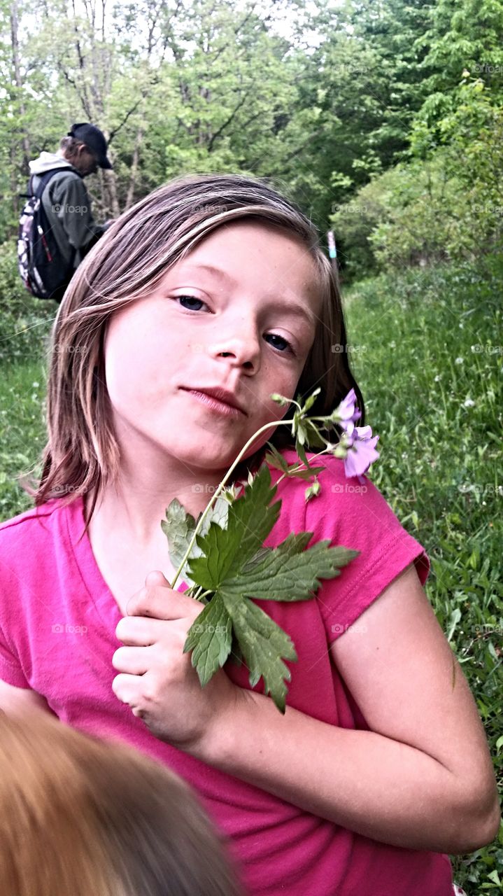 a girl and a flower. my daughter and her need to pose