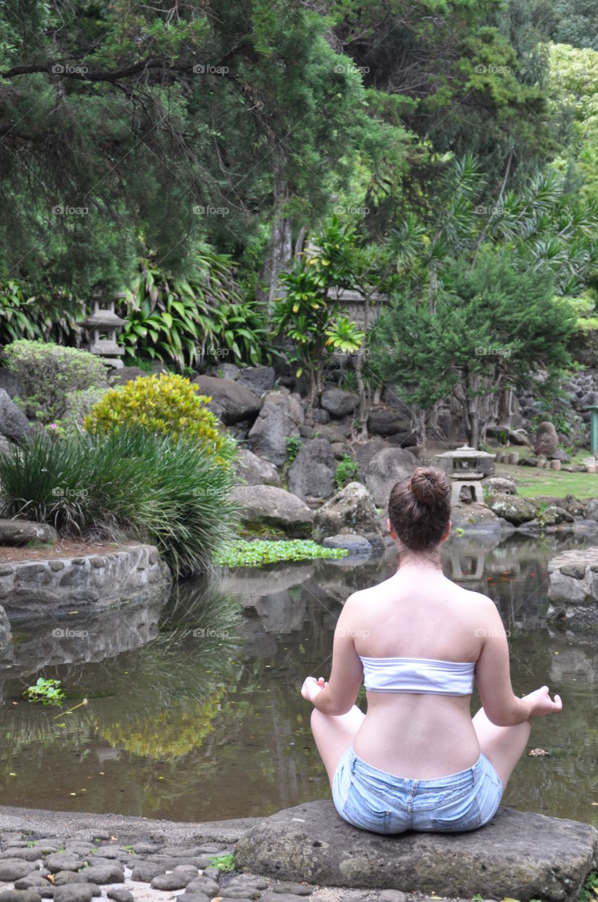 Meditation by a zen garden pond. 