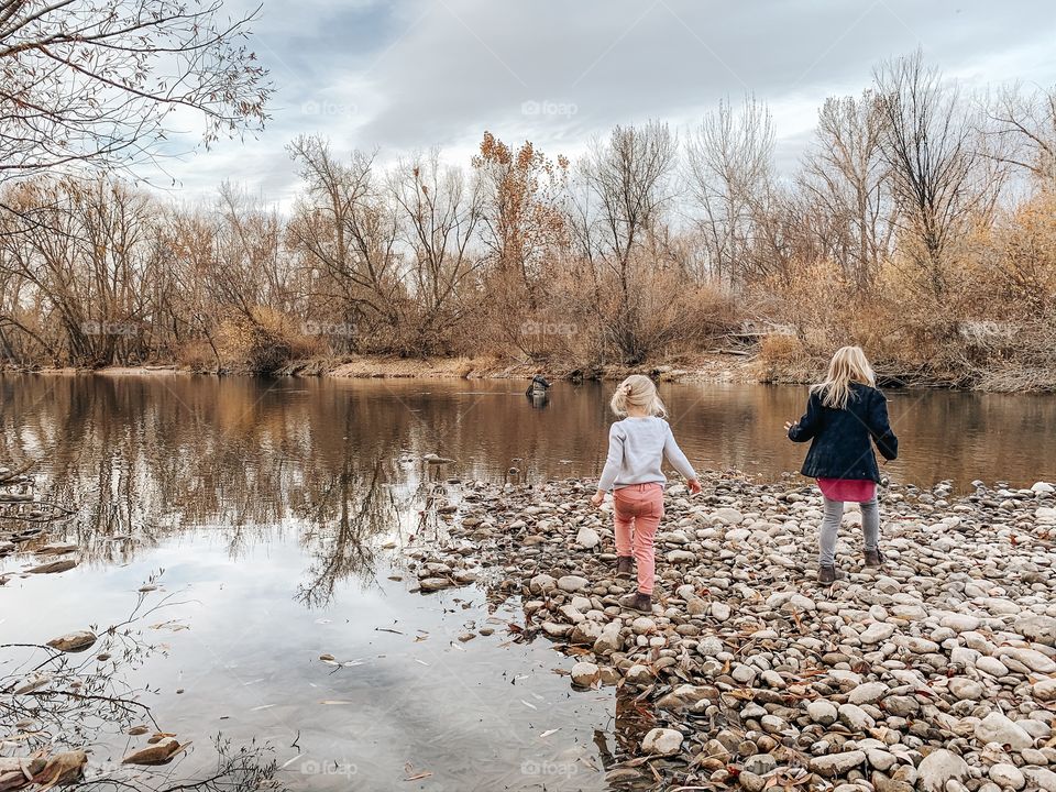 Children by water in autumn