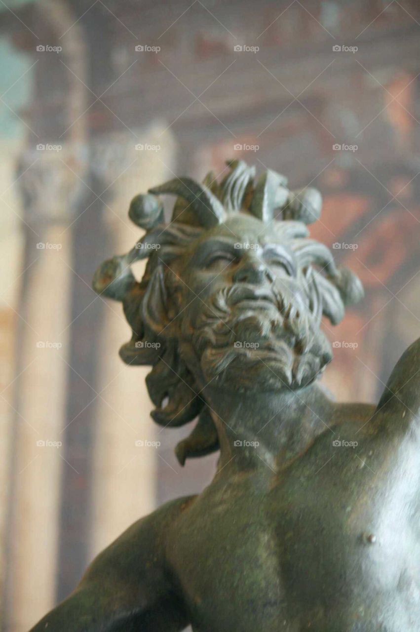 statue of Poseidon inside a vintage antique mansion