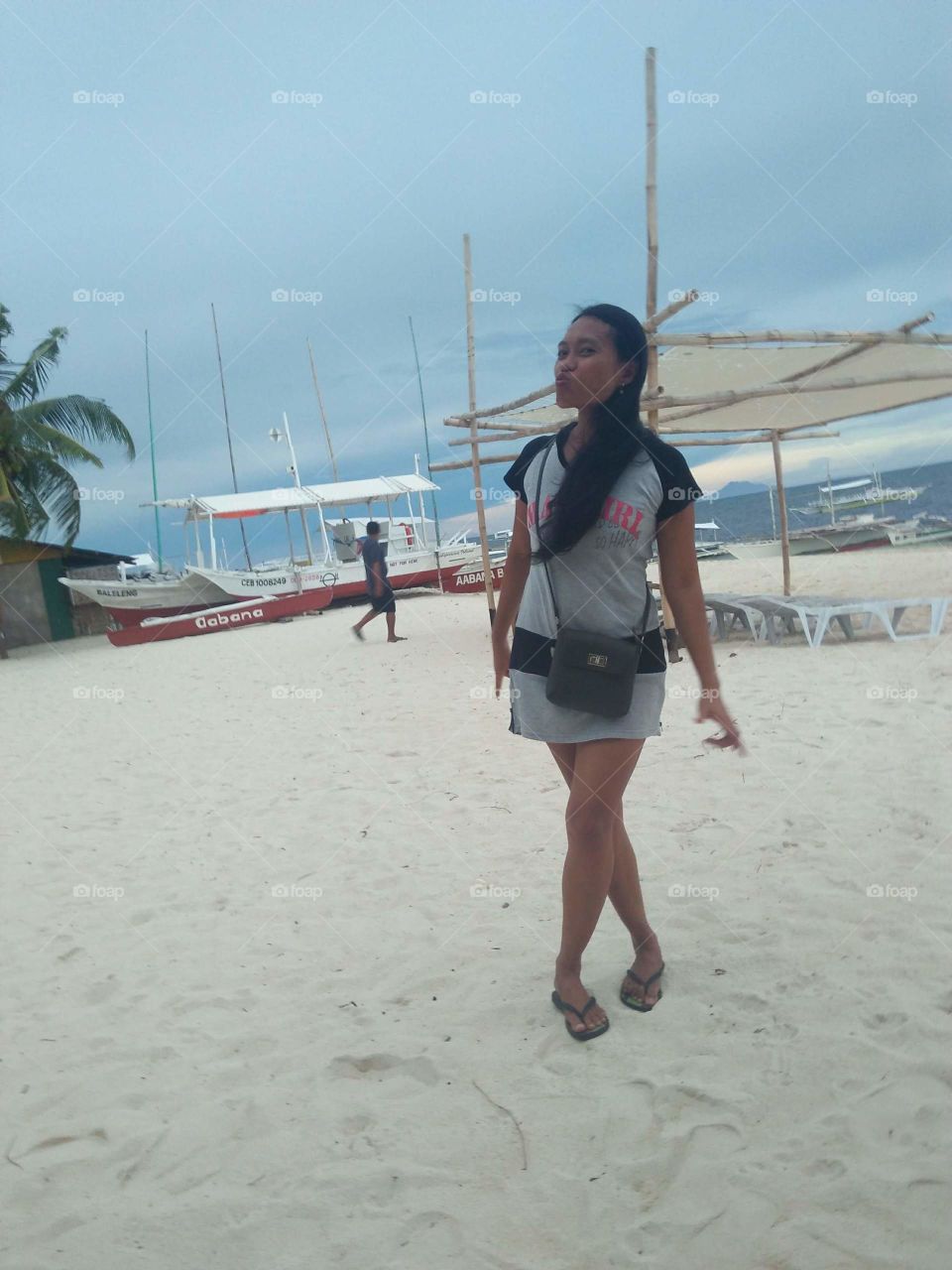 wearing mini dress while walking on the beach