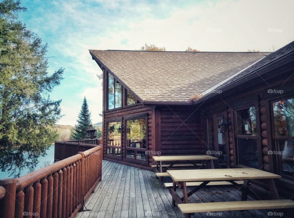 A wooden house near the lake in a forest