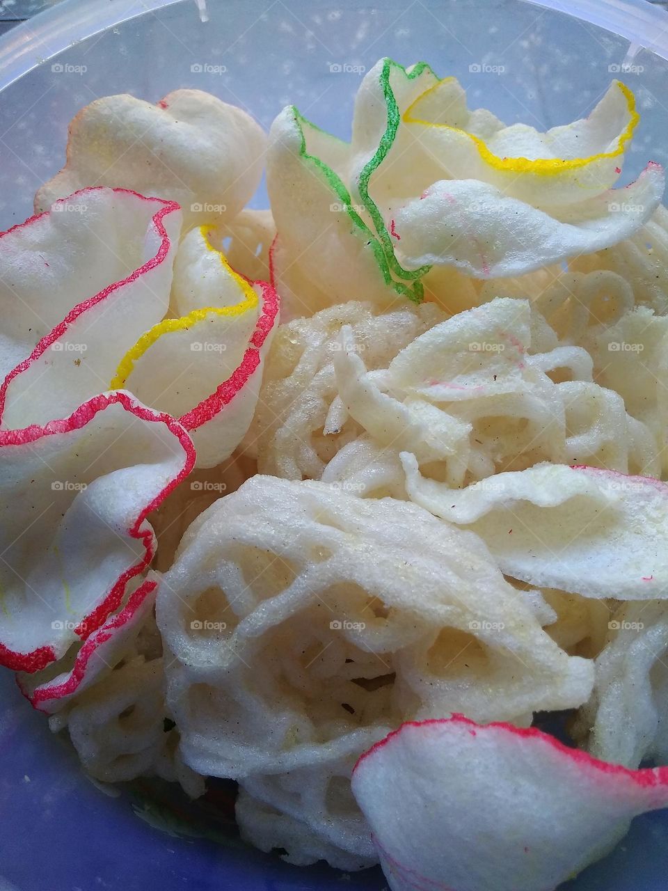 traditional food from Indonesia made from flour with a savory taste which is usually eaten as a side dish.well known as "kerupuk".