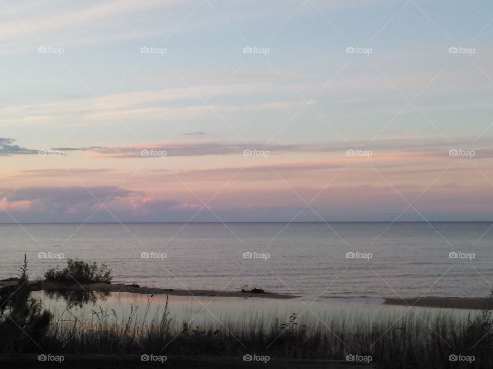 Pure Michigan. Lake Huron, at dusk as the sun is beginning to set. 