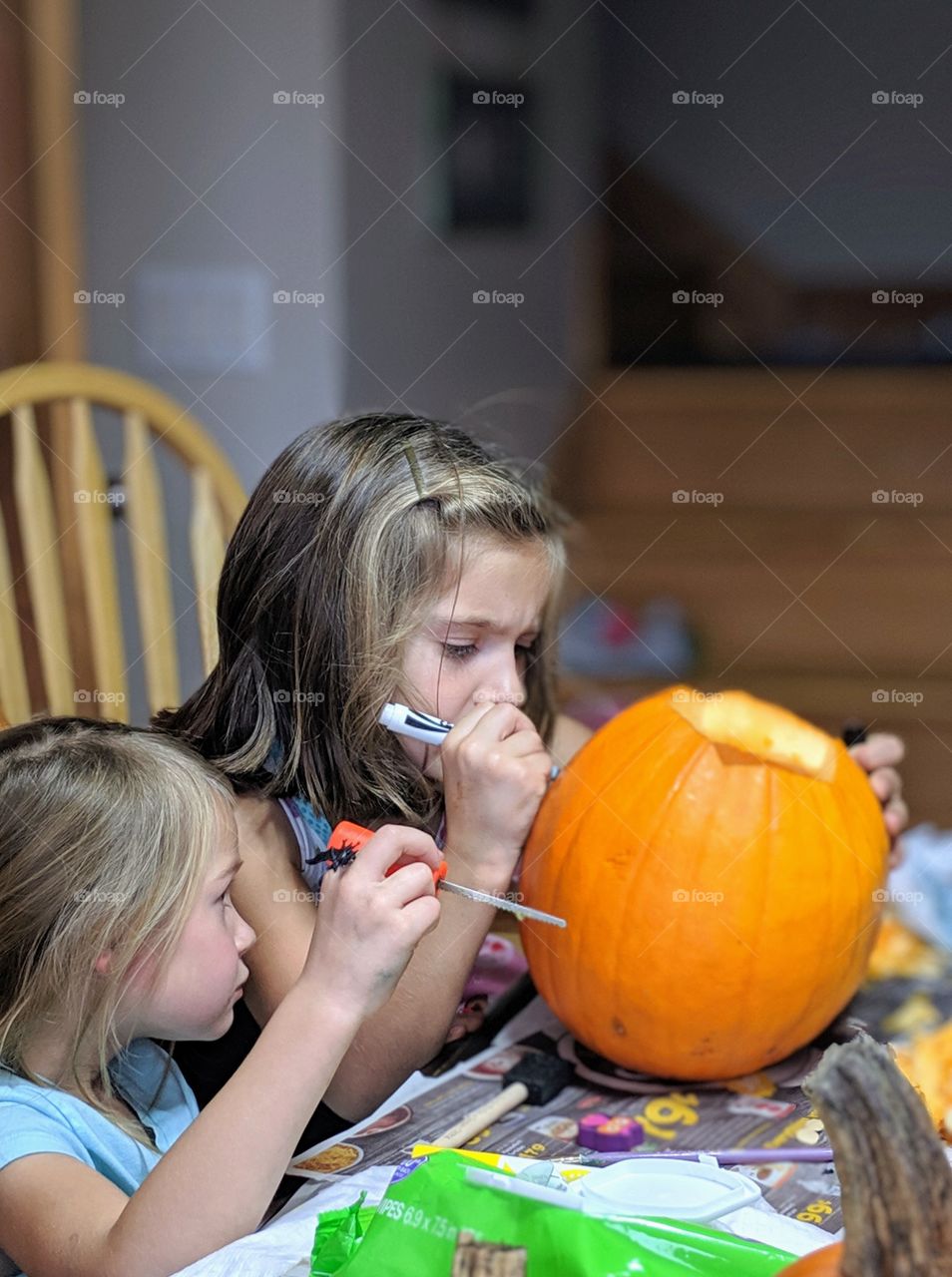 children carving pumpkins for Halloween