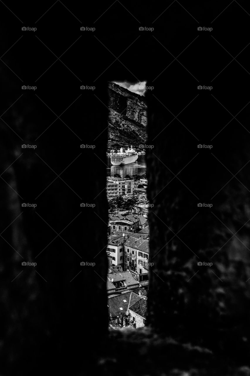 view of the pier, through the loophole of the ancient castle