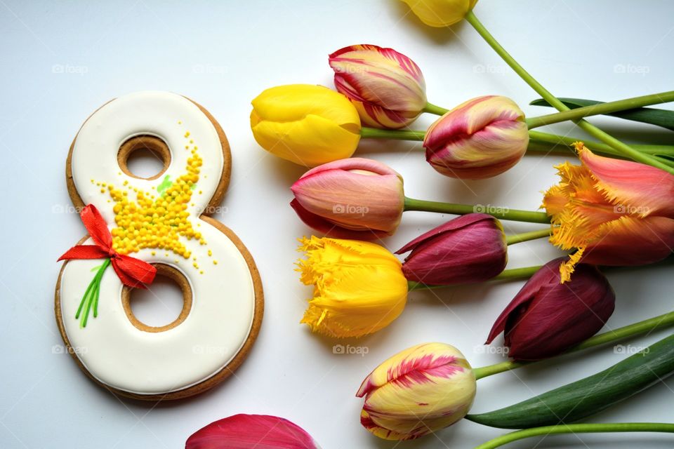 8 March gingerbread and colorful tulips on a white background women's day