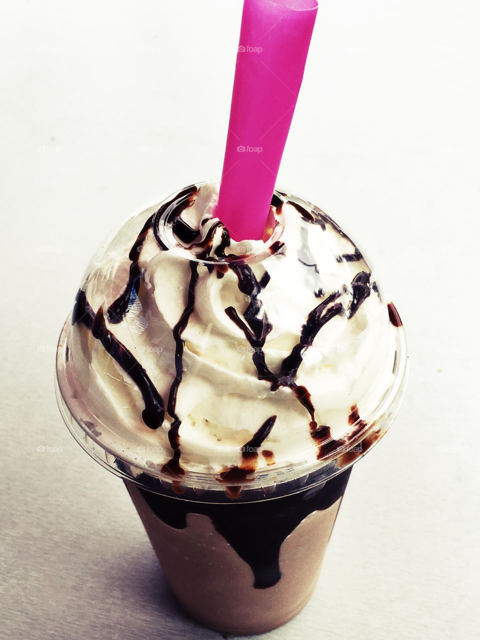 Overhead view of ice cream with drinking straw