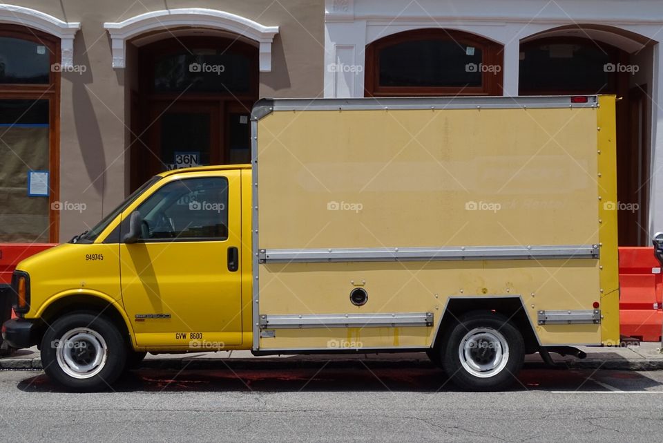 Yellow panel truck on street