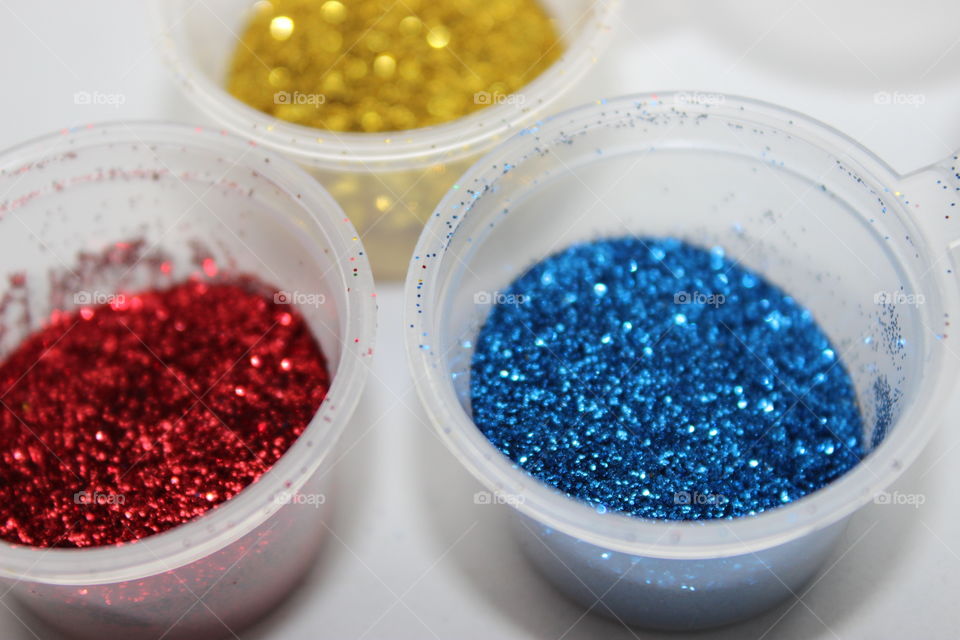 High angle view of glitters in containers