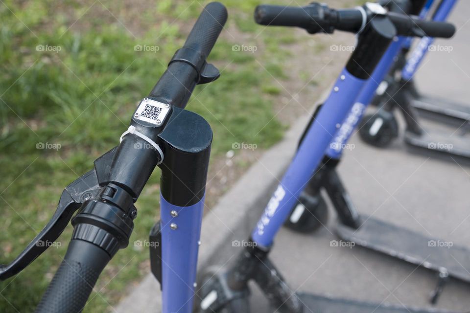 Eco-friendly transportation in city .  QR code of an electric scooter .