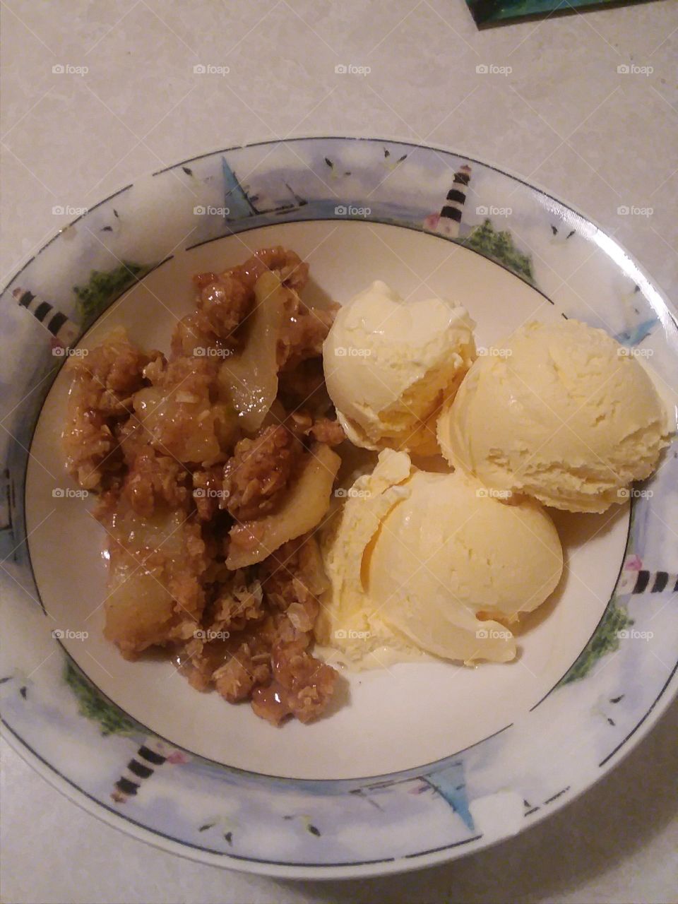 Apple crisp with vanilla ice cream in bowl 