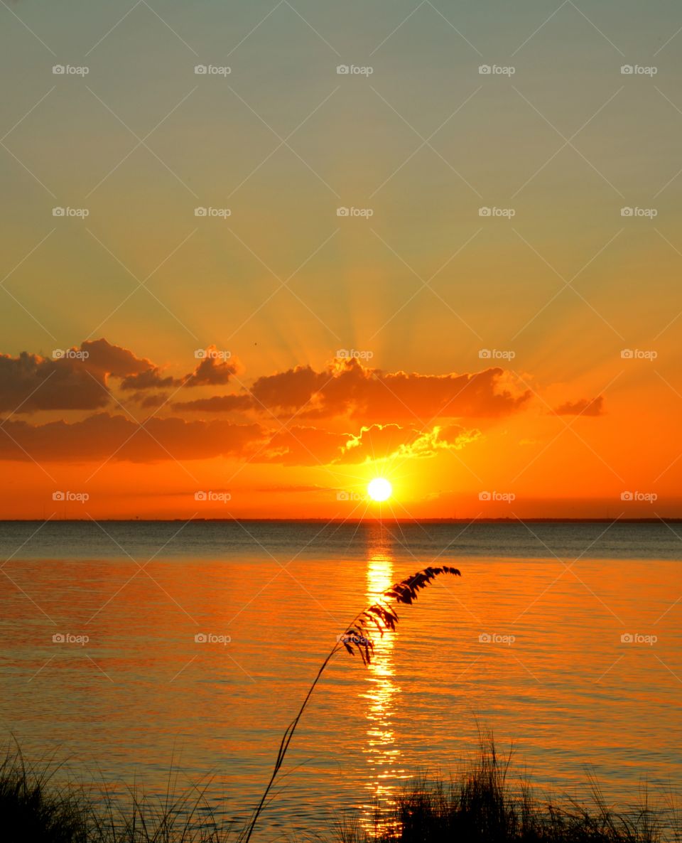 Bay engulfed by an explosive sunset 