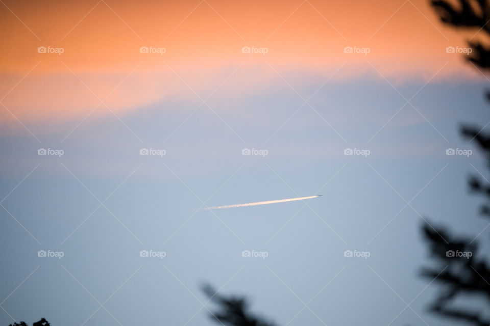 Plane on a blue and orange sky