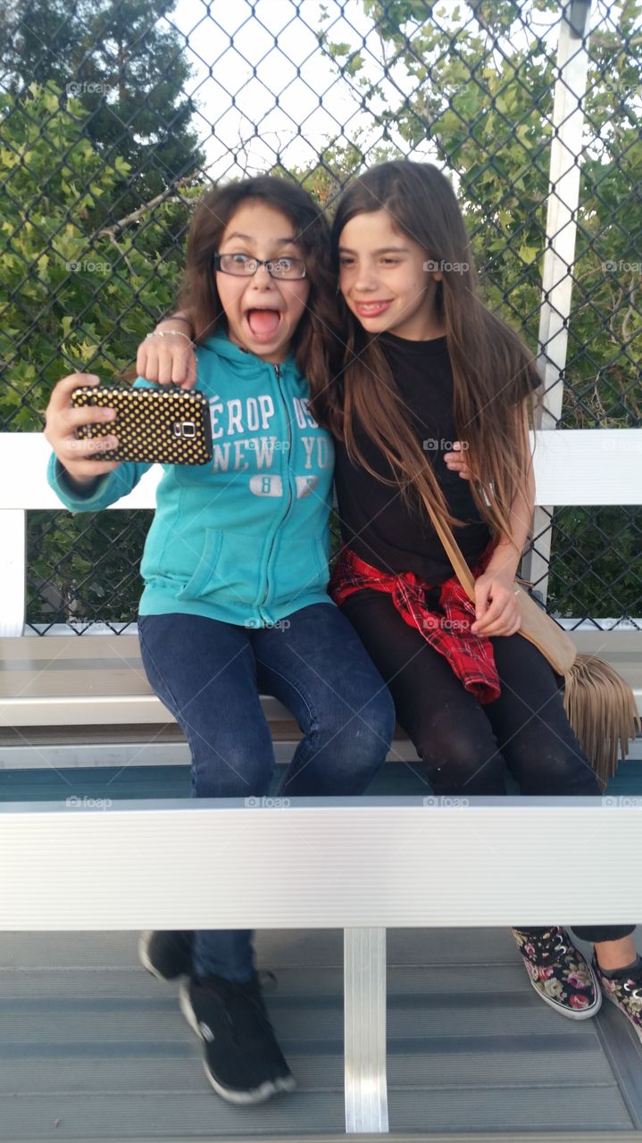 Teenage girls taking selfie
